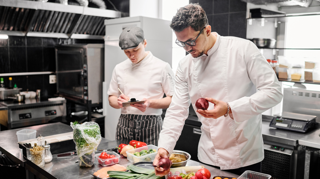 Chefs preparing ingredients in a kitchen demonstrating food traceability and sourcing visibility